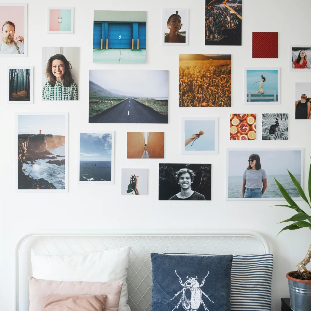Printed family photos hanging on a wall as decorative home memory displays.
