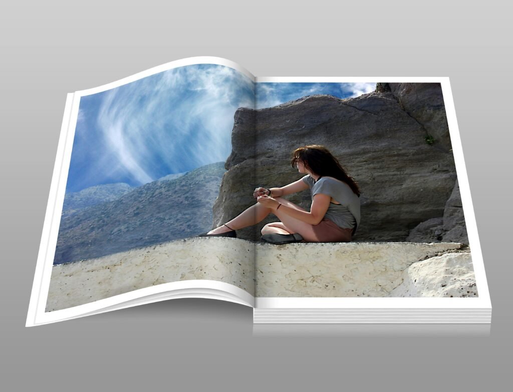Open photobook displaying printed photo pages on a clean surface with professional lighting.