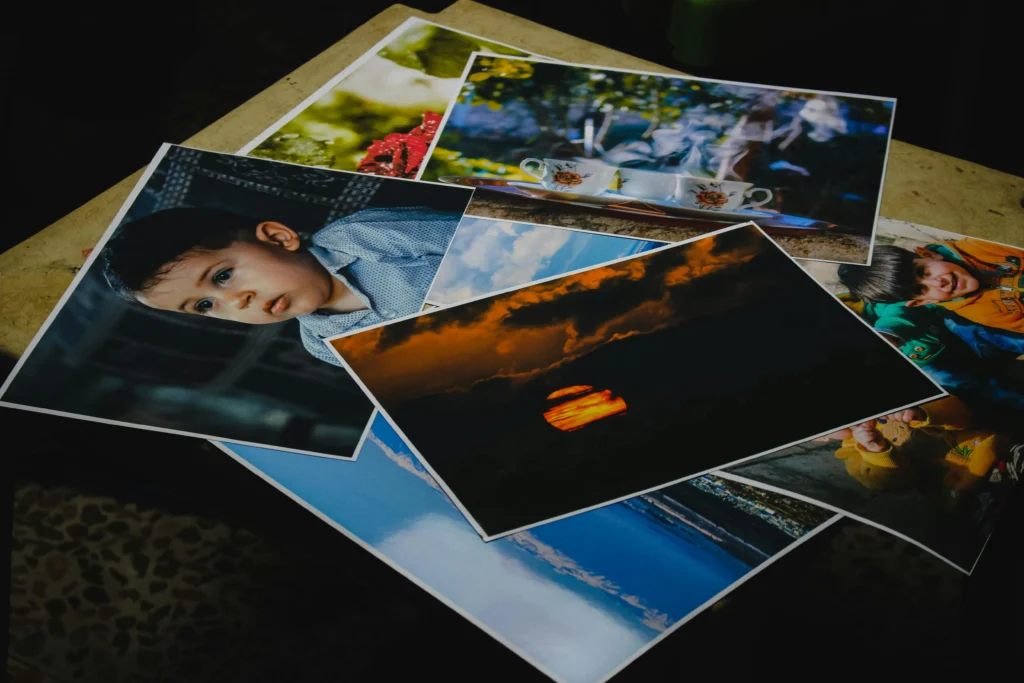 Printed photos displayed on a table in a photo studio.