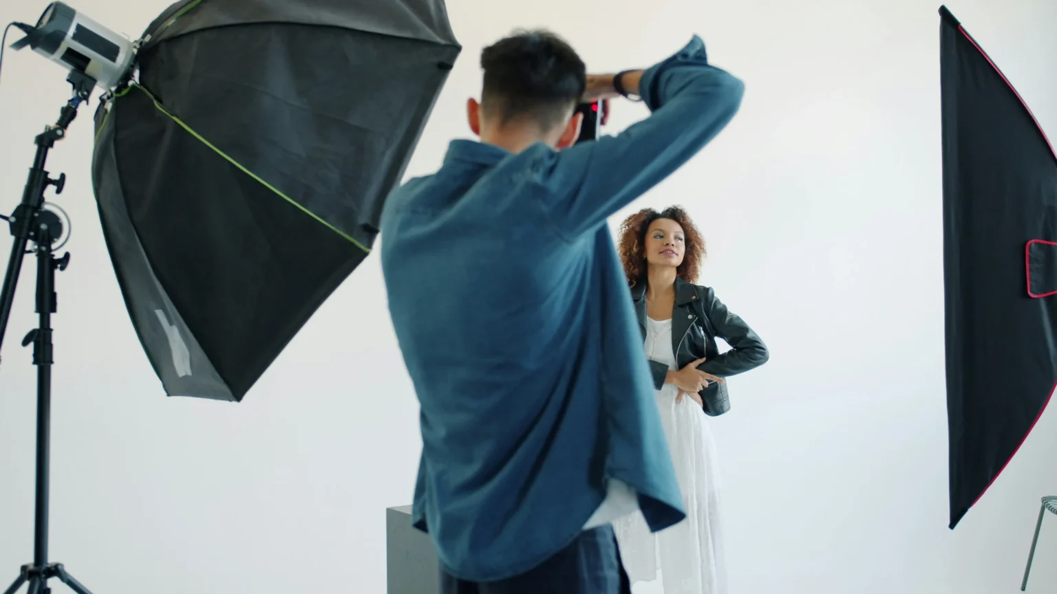 Woman taking a personal portrait photo in a professional photo studio.